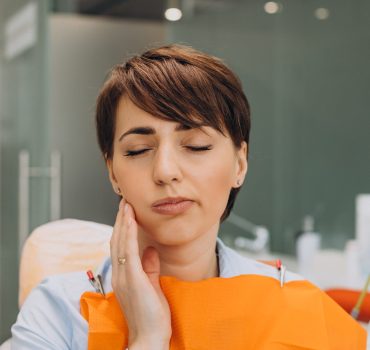 young-woman-having-tooth-ache-waiting-dentist-min-scaled-1.jpg